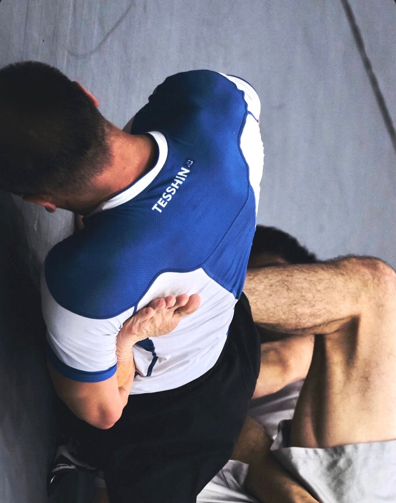 Tesshin athlete finishing a straight ankle lock during a no-gi BJJ competition