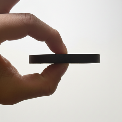Side-view of Tesshin black finger tape, held up by hand for reference
