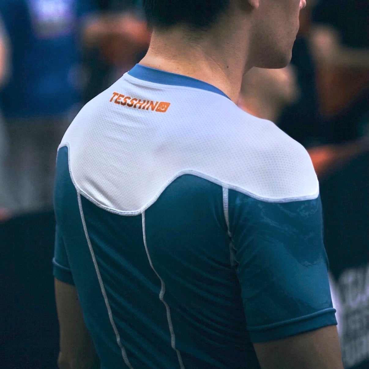 Tesshin athlete prepares for his match, wearing the Coral Blue rash guard