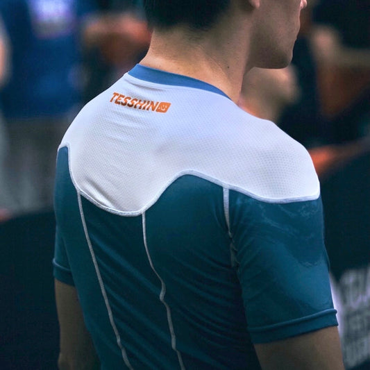 Tesshin athlete prepares for his match, wearing the Coral Blue rash guard